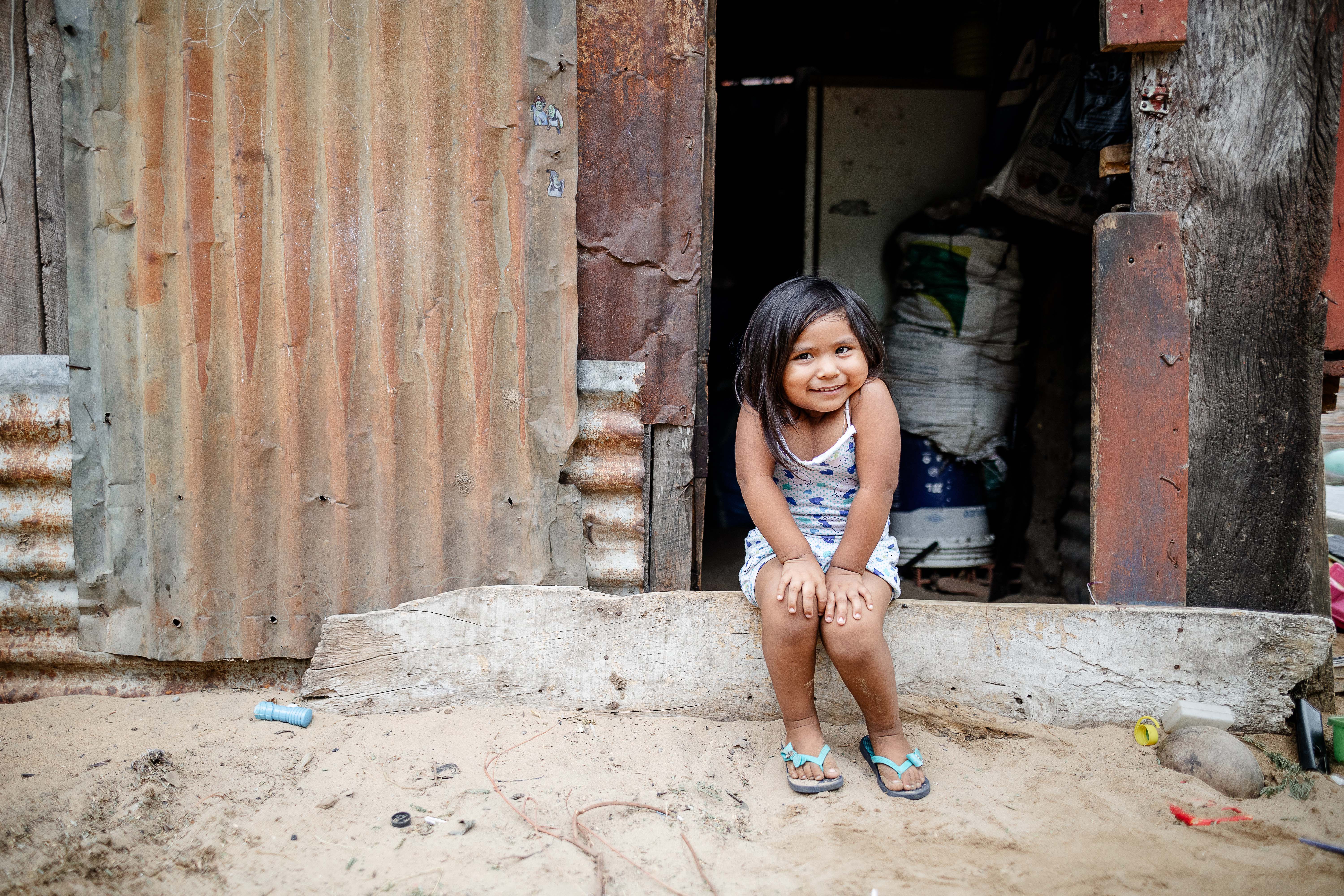 Girl smiling outside a house