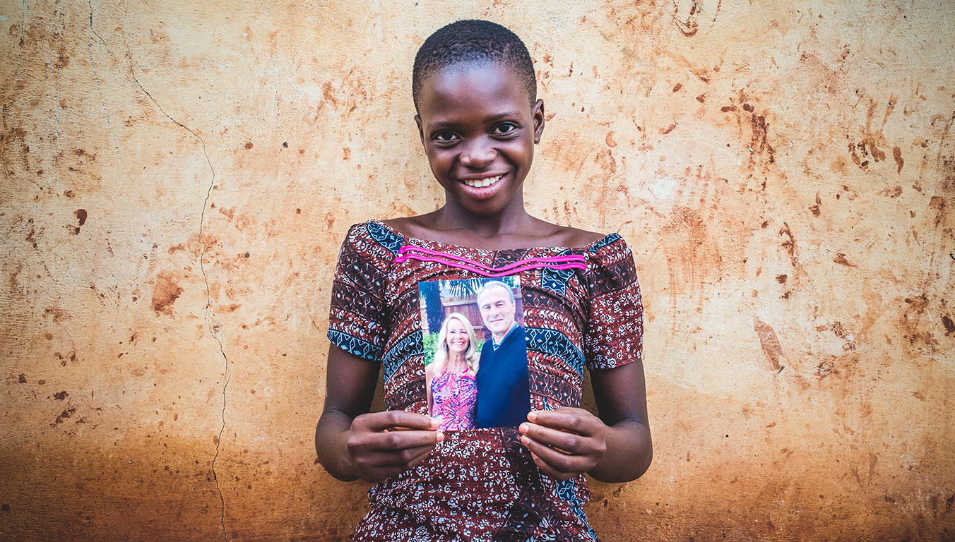 Ablavi holds a photo of her sponsors