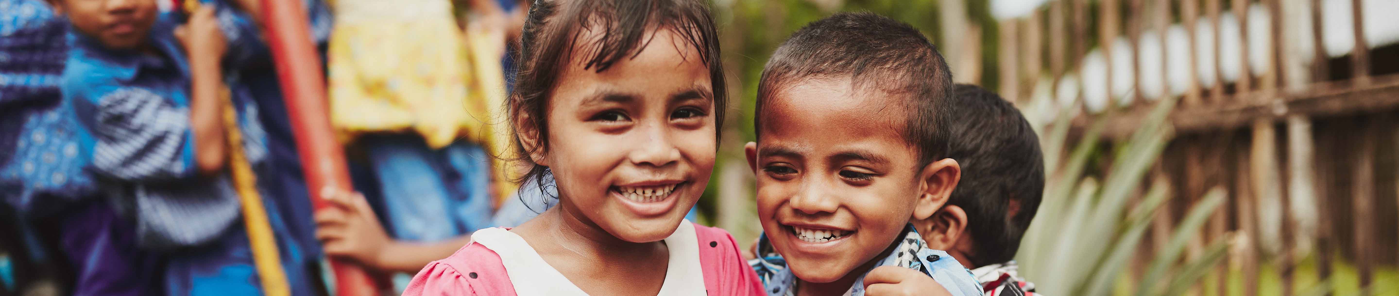 A boy and a girl smiling and laughing