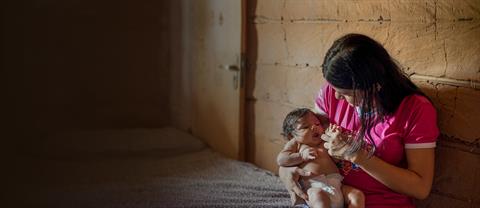 A woman holds a baby