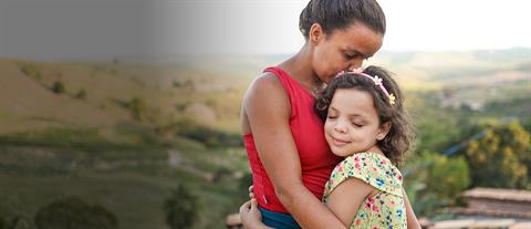 a mother and daughter hug each other