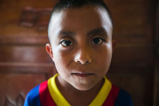 A boy wearing colorful shirt