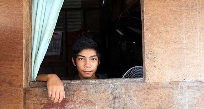 Boy looking out a window