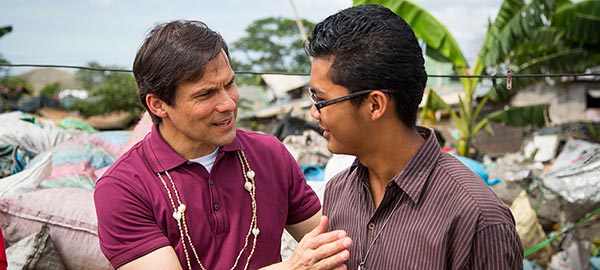 Santiago Jimmy Mellado in conversation with another man