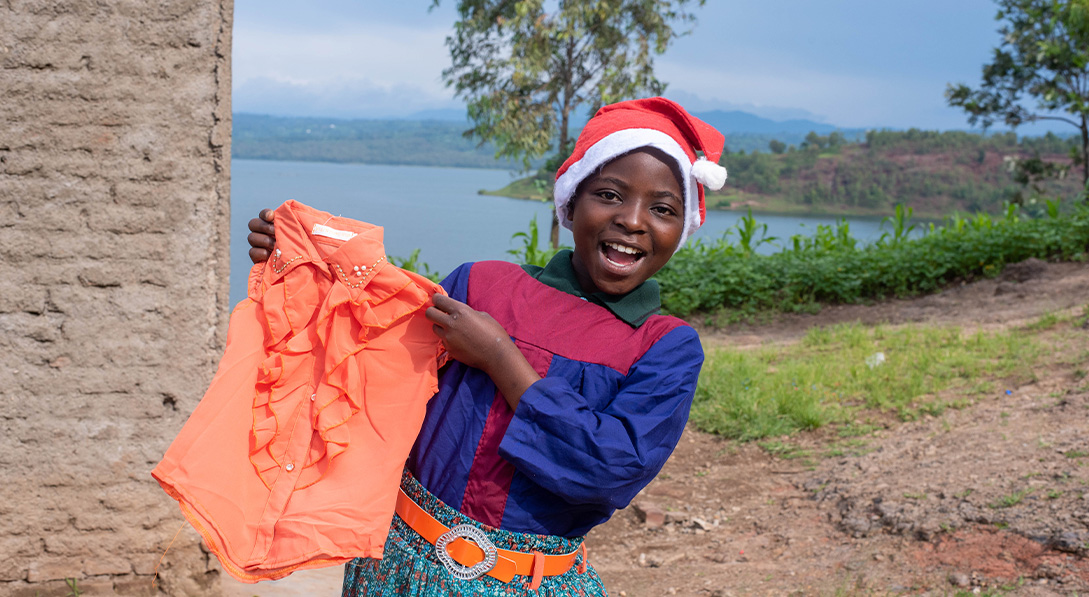 Fillette smiles with gift of an orange shirt