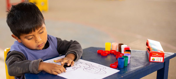 a young boy learning to finger paint