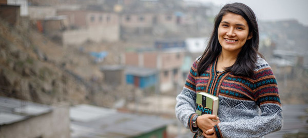 a young lady standing in her city and smiling