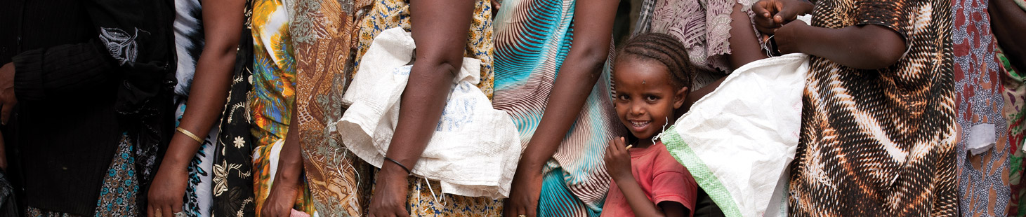 A young girl standing in line with other women