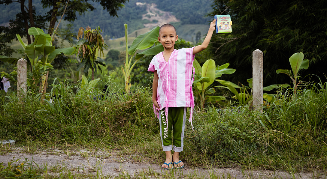 a boy holds his Bible