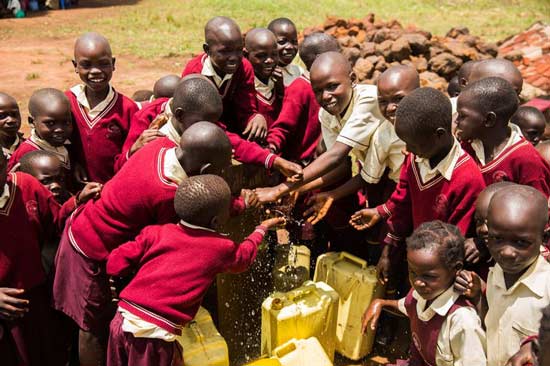 Children getting water from the well