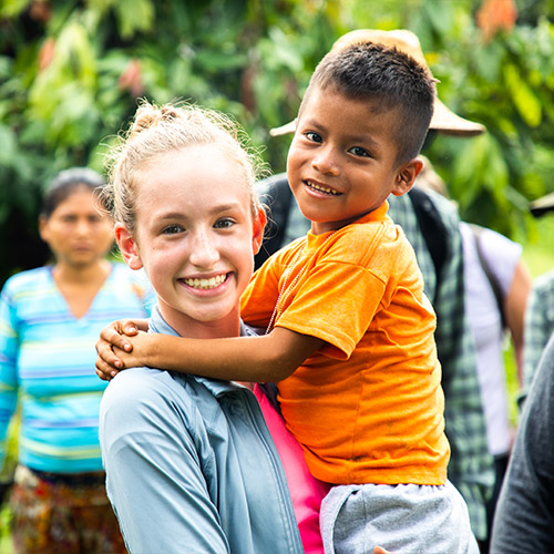 a sponsor and child smiling