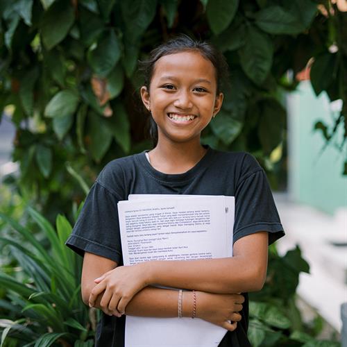 a girl holds letters from her sponsor