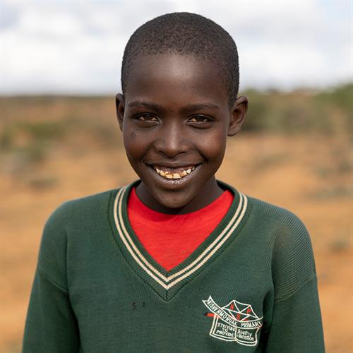 a boy smiles at the camera