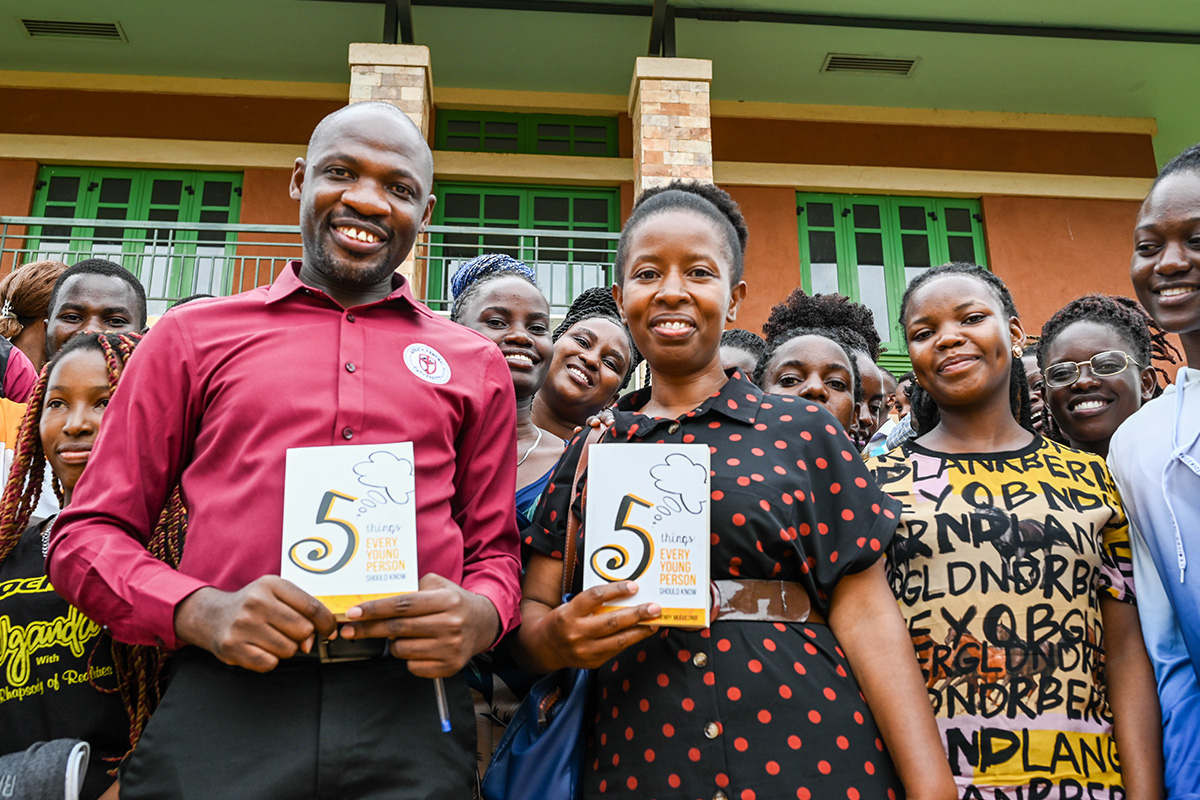 Henry holding a copy of his book, "5 Things Every Young Person Should Know."