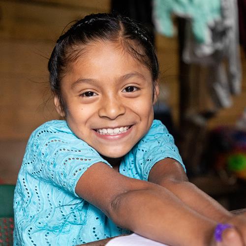 a girl smiles at the camera