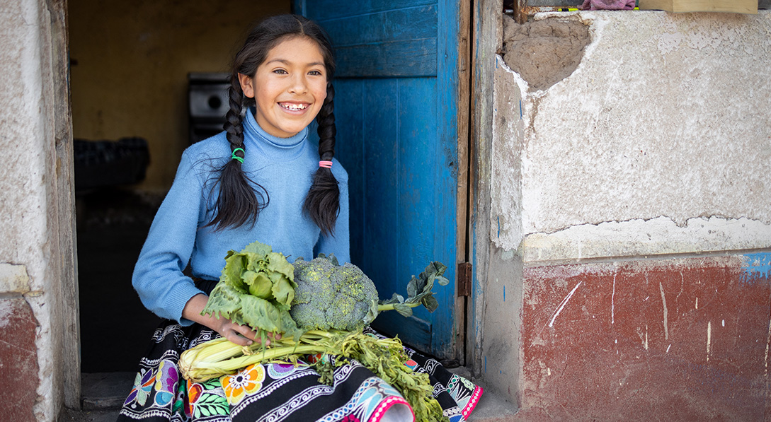 Girl holding vegetables