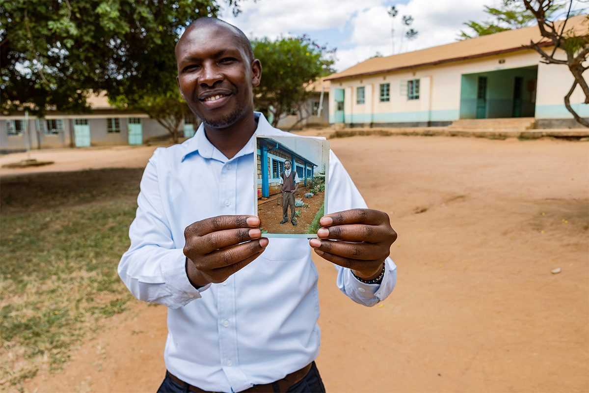 Michael holds a photo of his younger self.