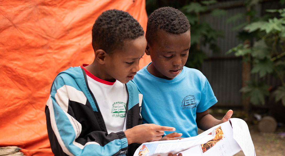 boys reading a letter