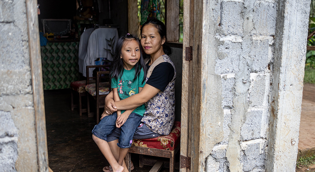 Junadel sits on her mother's lap