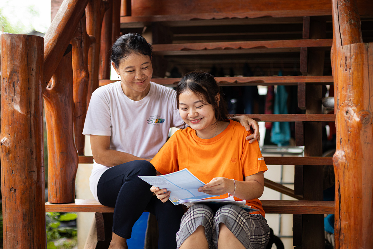 girl smiles while reading letter 