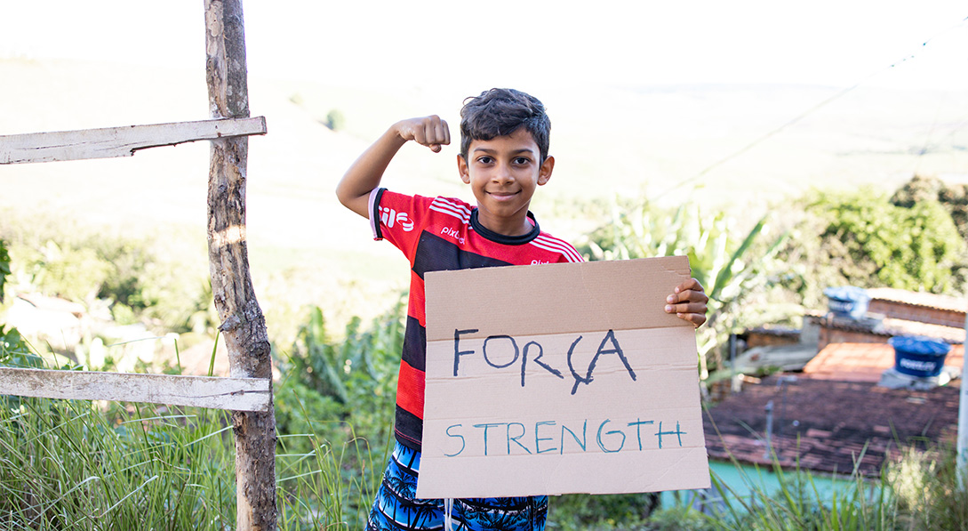 Lucan holds sign that says "strength"