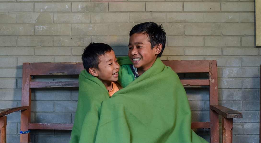 child smile wrapped in the gift of a blanket