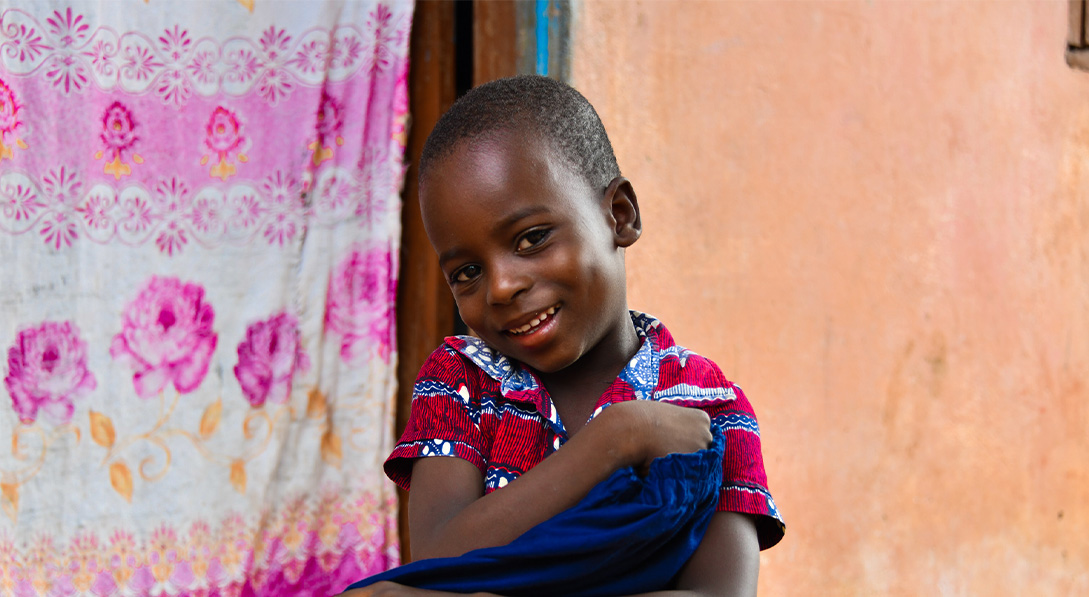 child holds gift of clothes