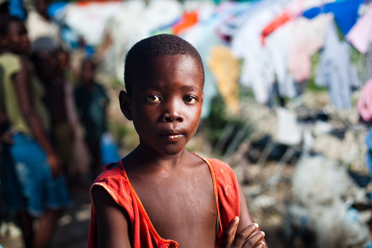 child in red looks at camera