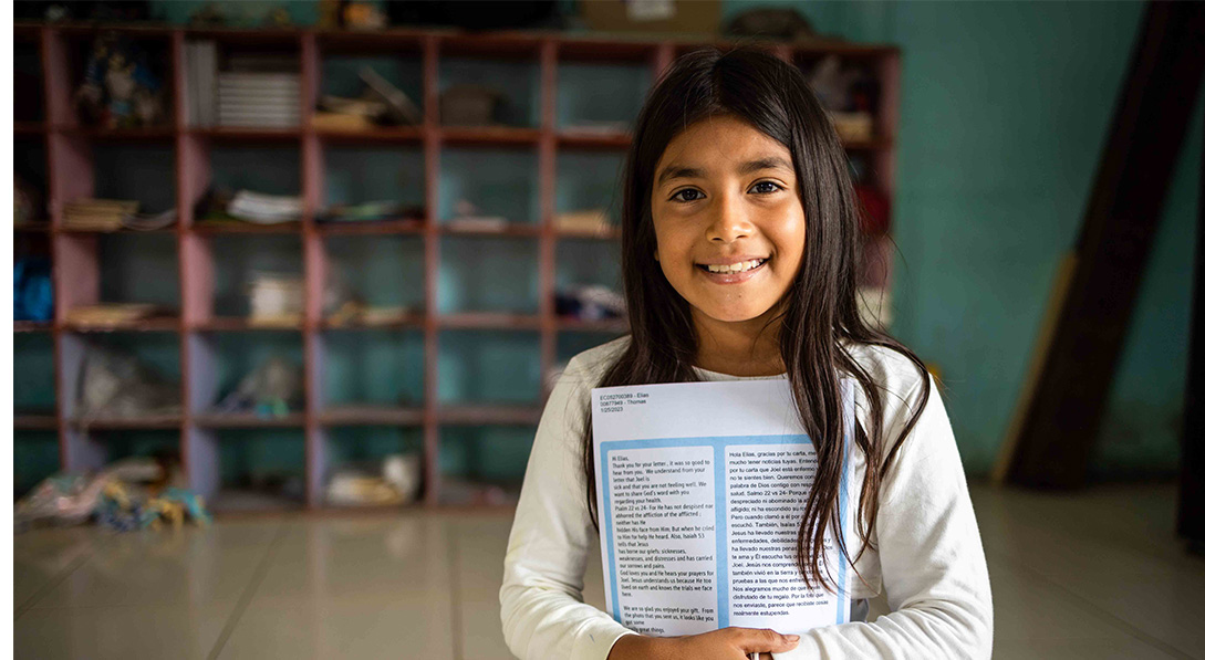 girl holds letter close