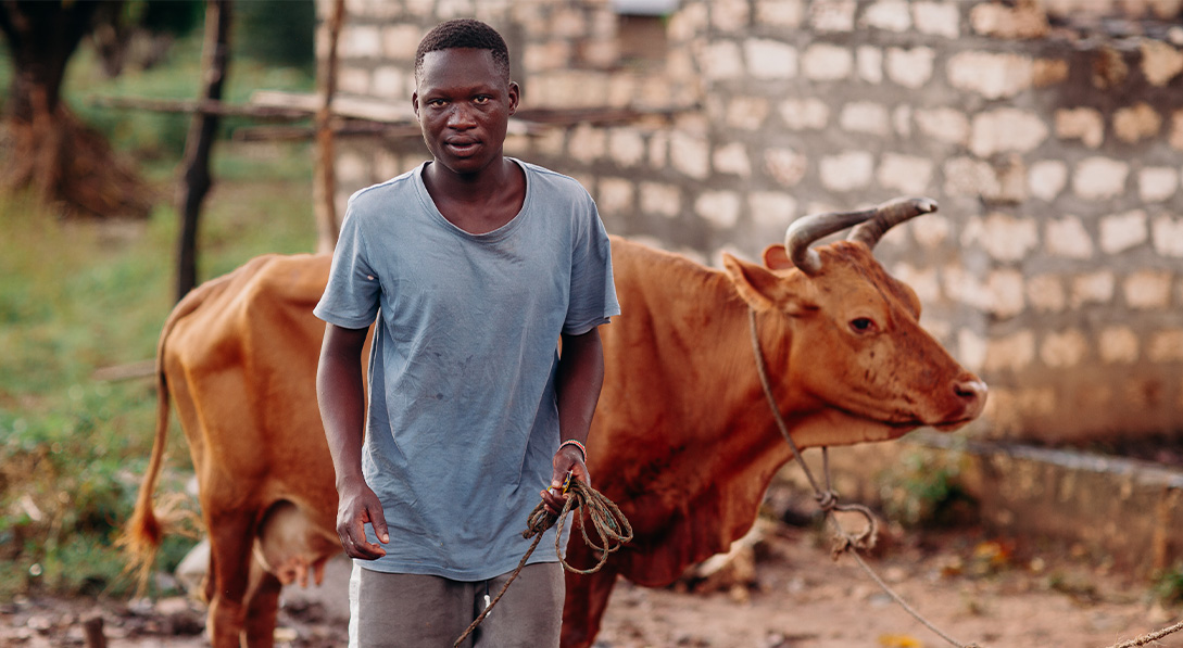 Davis stands with cow