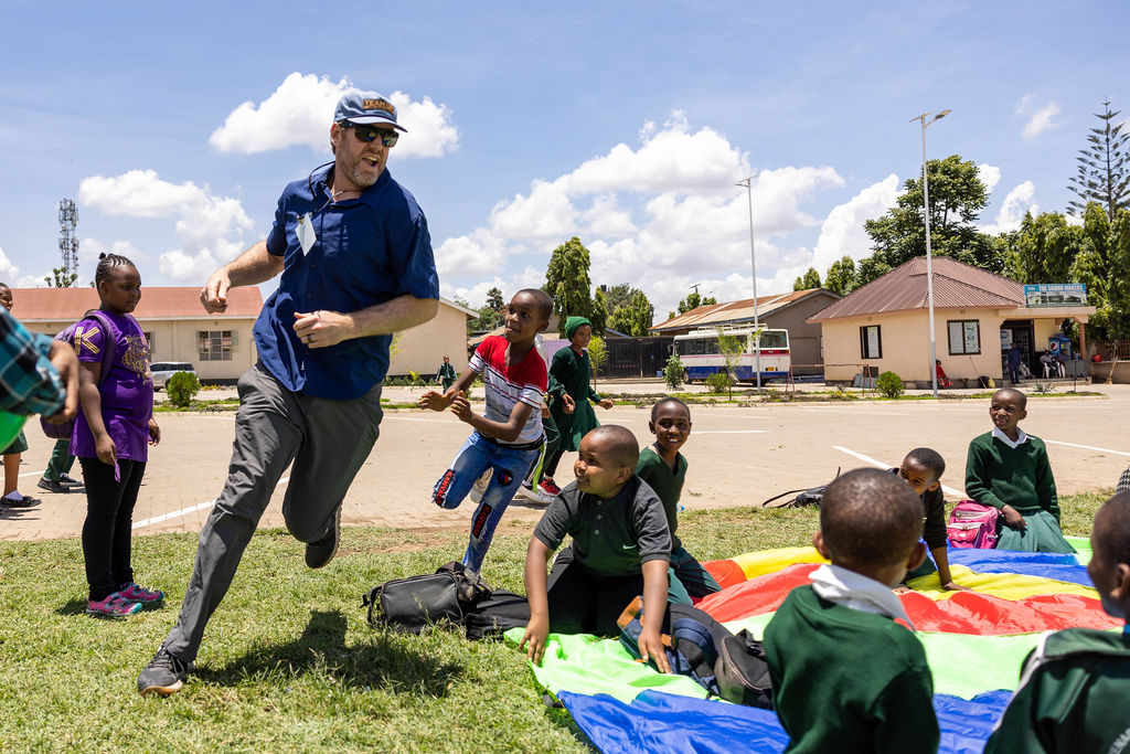 Pro Football athlete plays with children in Tanzania