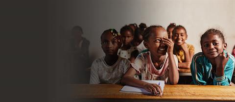 Girls sitting at a school table