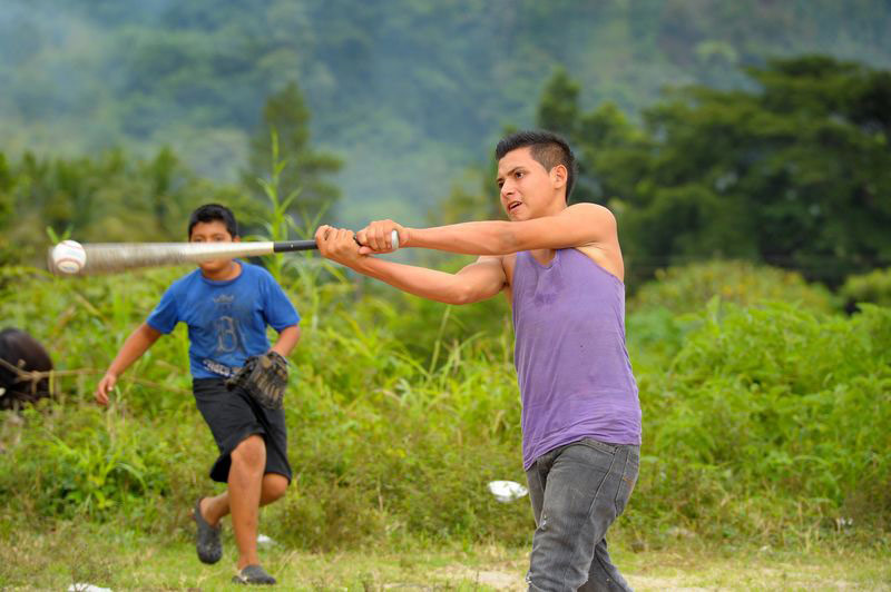 Teen boys playing baseball