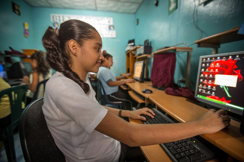 A teen girl working on a computer