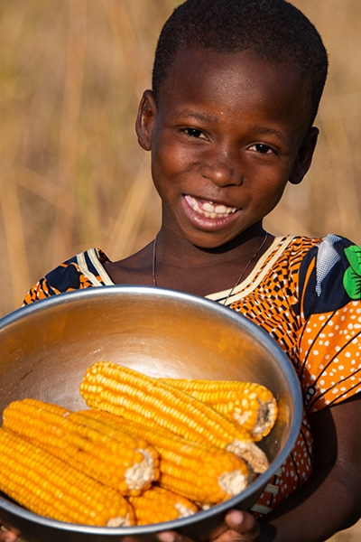 Ester hold a bowl of corn