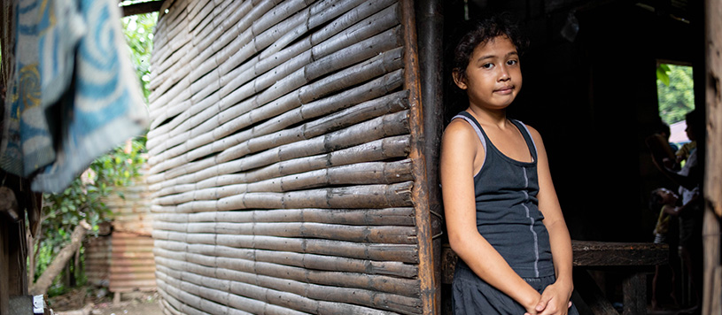 a child stands in their doorway