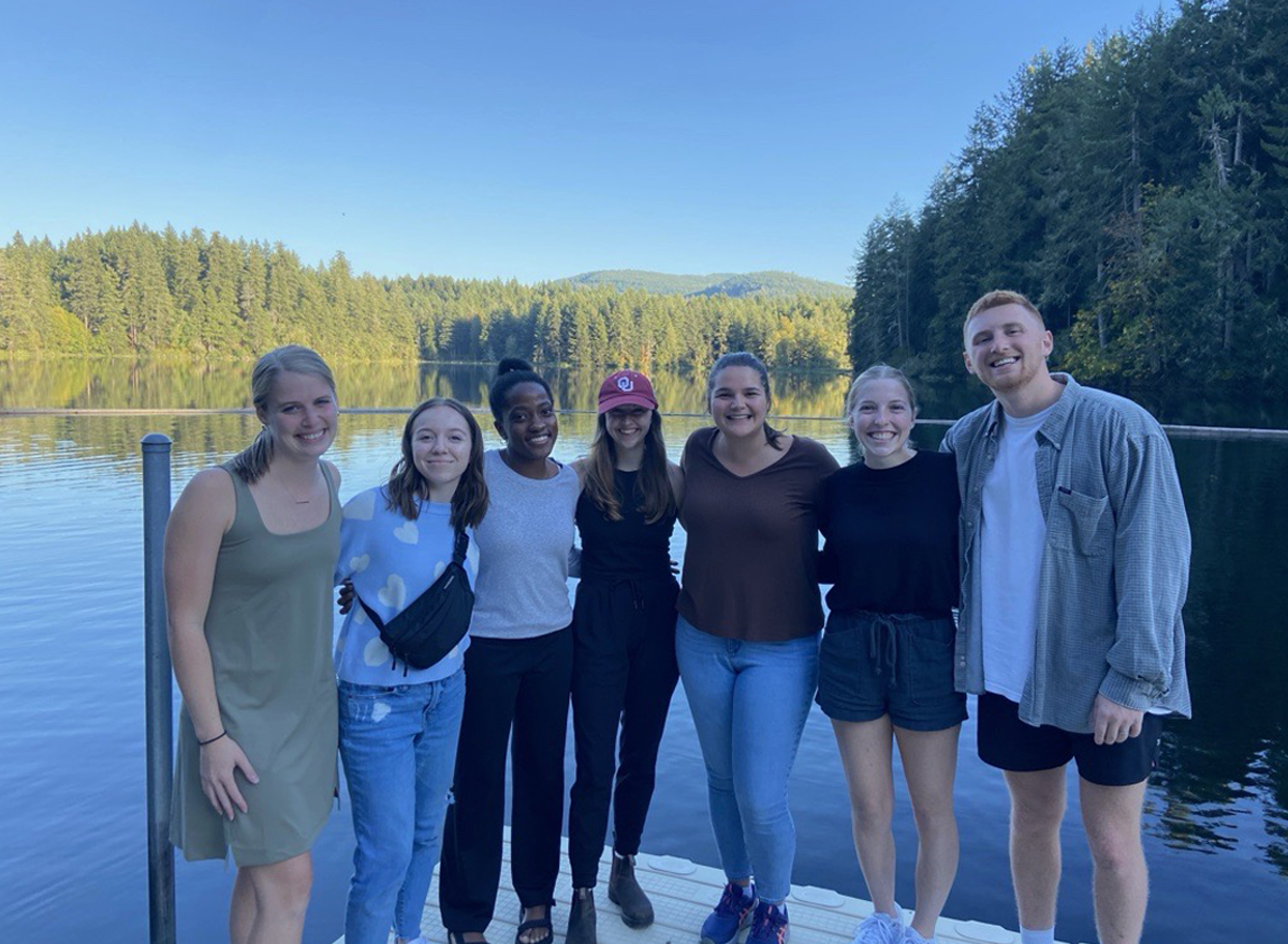 Group of Compassion employees posing for a picture on a dock