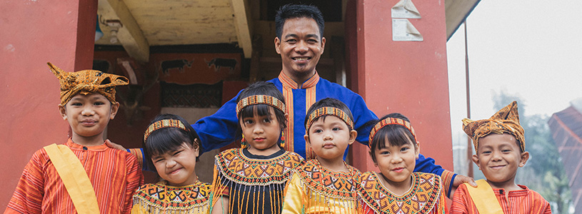 a pastor stands with a group of students