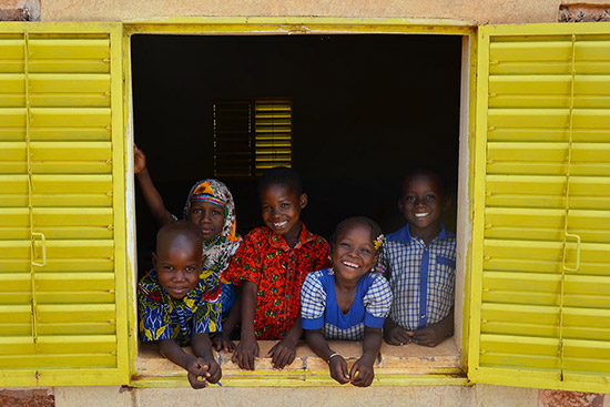 Students looking through window and smiling