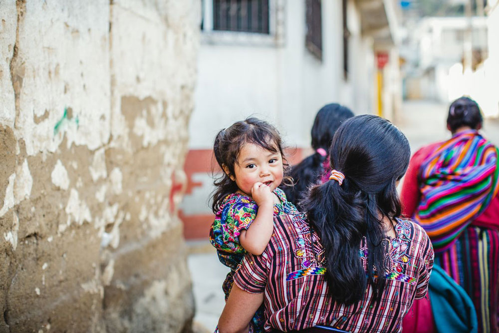 A mother holds a baby in her arms