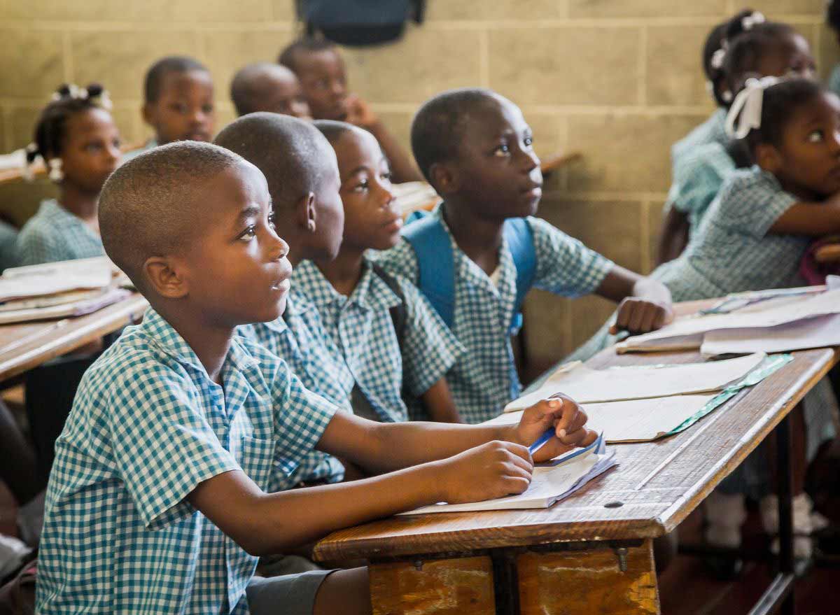 A group of children engage in the classroom activity at their child development center