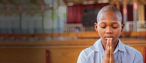 A young boy praying