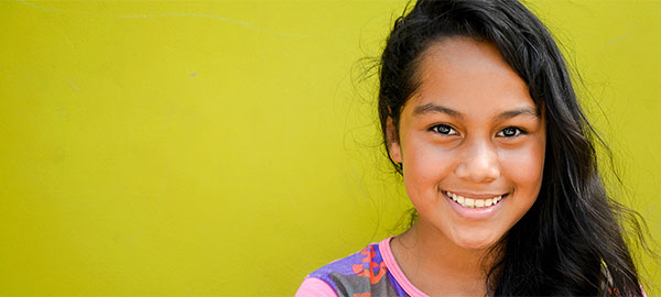 A girl with long hair cascading over one shoulder.