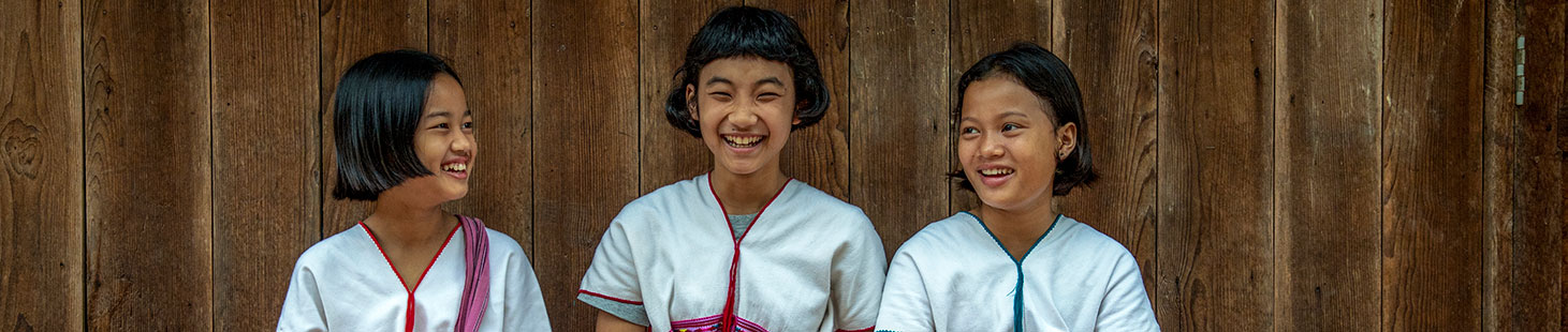 three asian girls laughing together