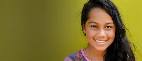 A girl with long hair cascading over one shoulder