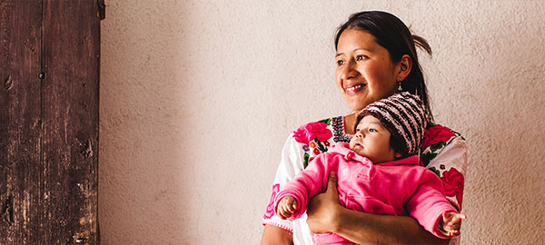 A smiling mother holding her baby