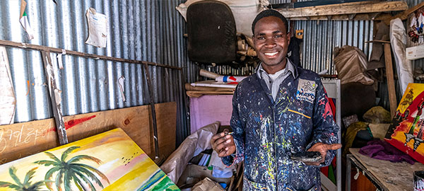 A young man in painter's clothes