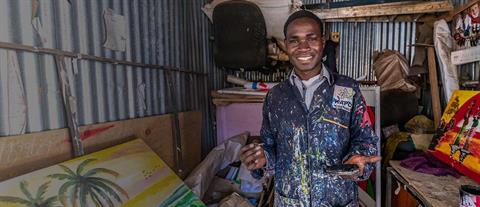 A young man in painter's clothes