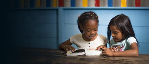 Two girls reading books