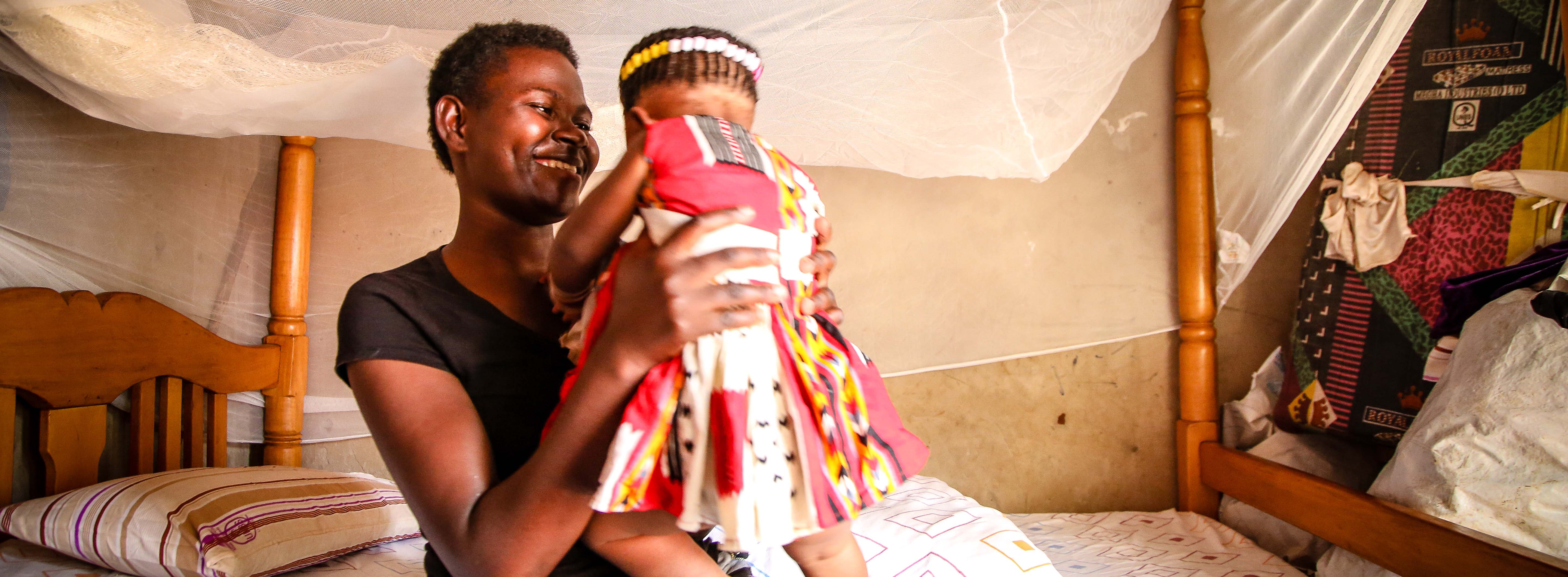 A woman smiling at a baby